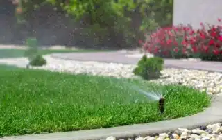 sprinkler system watering a landscaped yard