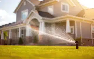 Automated lawn sprinkler and garden irrigation system watering residential landscape in Connecticut backyard for efficient water management